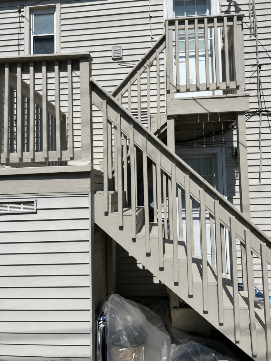 Exterior stairs and deck railings repainted in gray — after