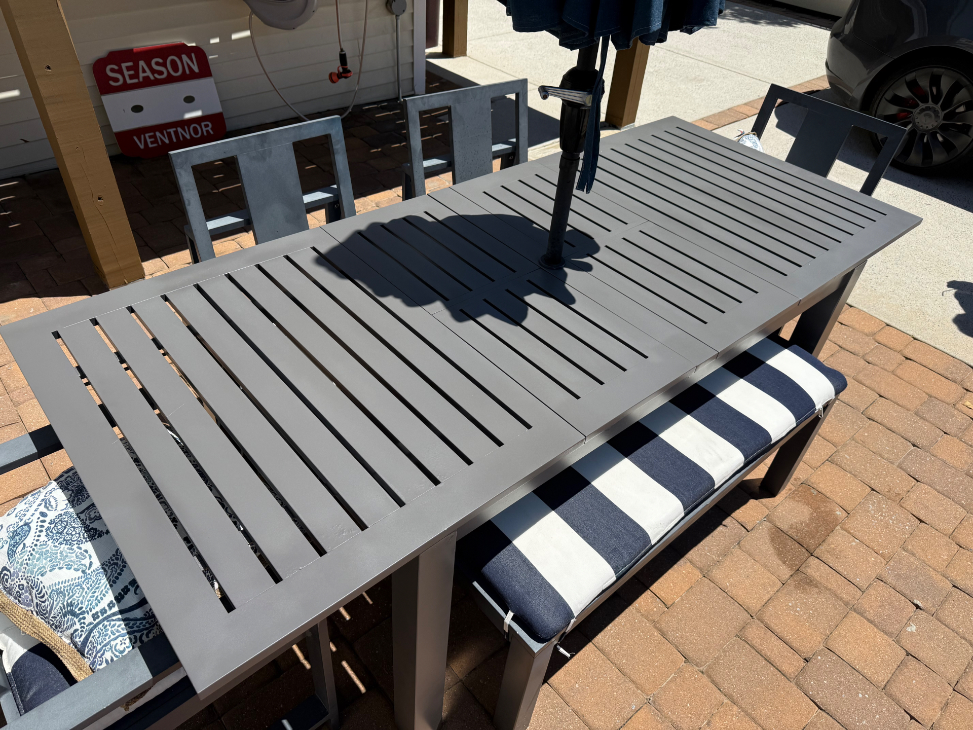 Patio dining table refinished in gray after sanding and repainting