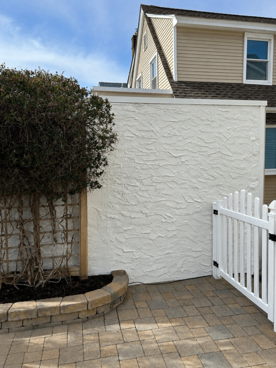 Smooth freshly painted white stucco courtyard wall