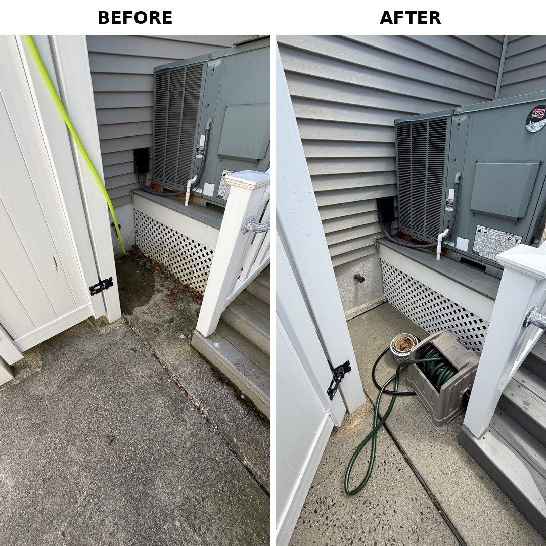 Concrete patio and siding around AC unit soft-washed clean